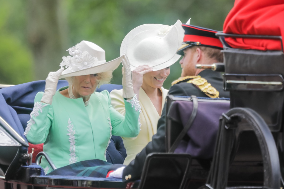TRKKP6 London, UK. 08th June, 2019. HRH Catherine, Duchess of Cambridge and HRH Camilla, Duchess of Cornwall, keep hold of their hats while sharing an open top carriage along The Mall on a windy day. Trooping the Colour, The Queen's Birthday Parade, London UK Credit: amanda rose/Alamy Live News Credit: amanda rose/Alamy Live News