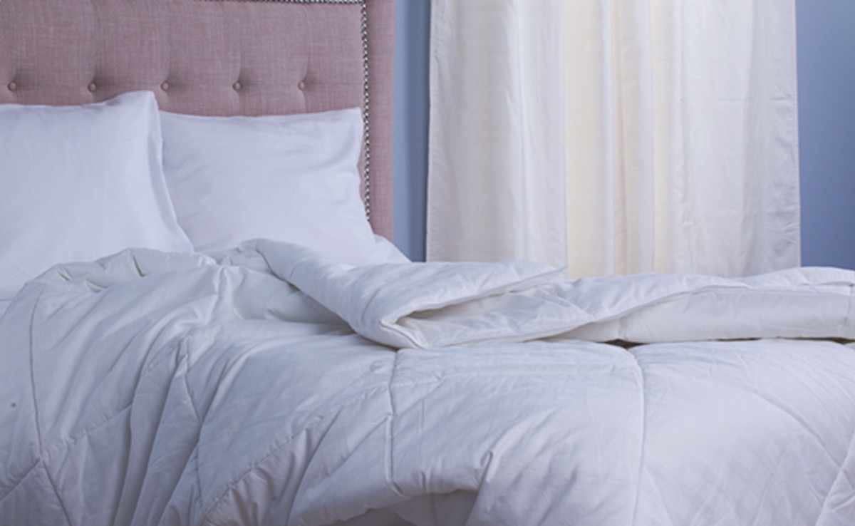 white comforter on messy bed, cooling products