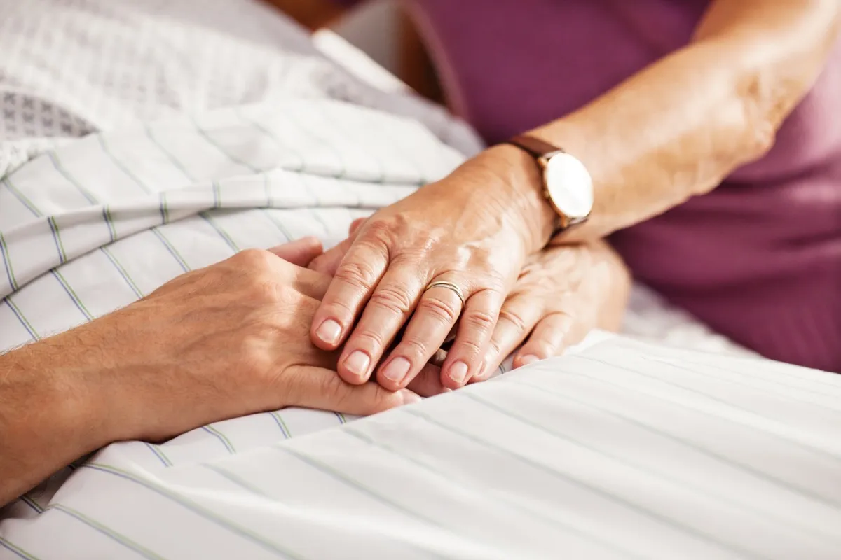 couple holding hands in the hospital