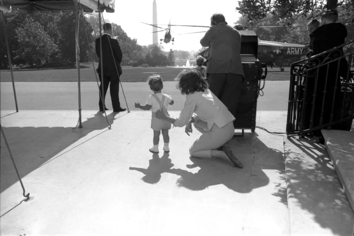 Jackie Kennedy playing with her son