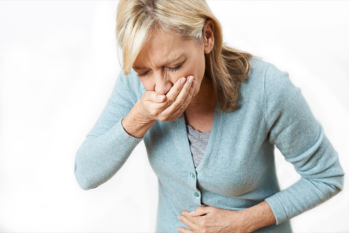 Older Woman is Nauseous and About to Vomit Signs of Poor Health After 50