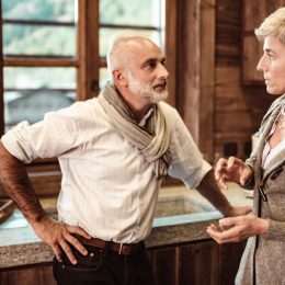 older couple fighting with each other in kitchen