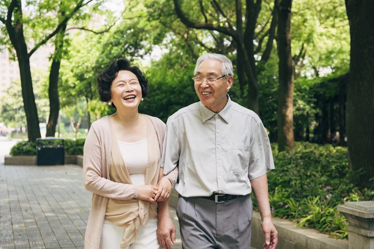 old couple walking a trail together