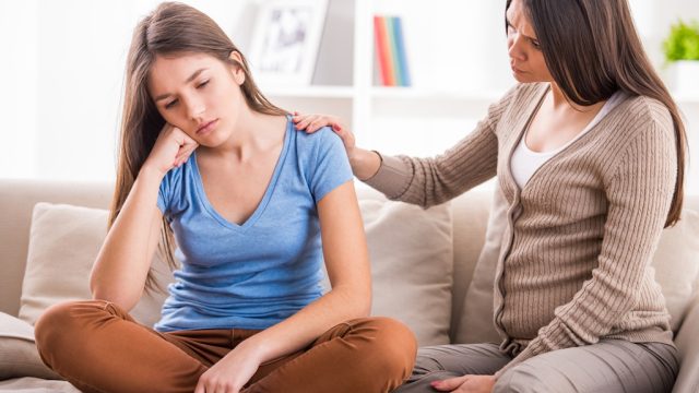 mom talks to young teenage daughter about bullying