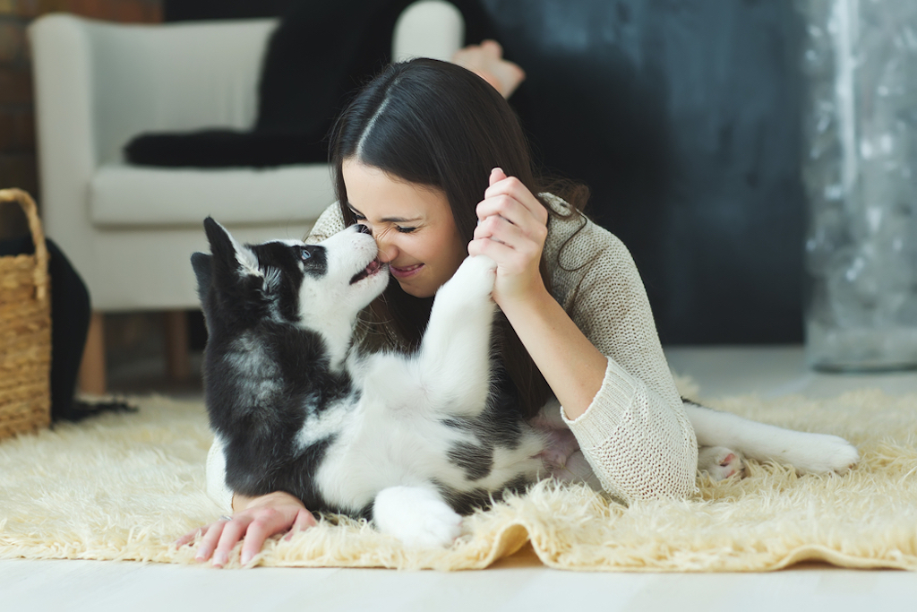 woman playing with dog, ways to feel amazing