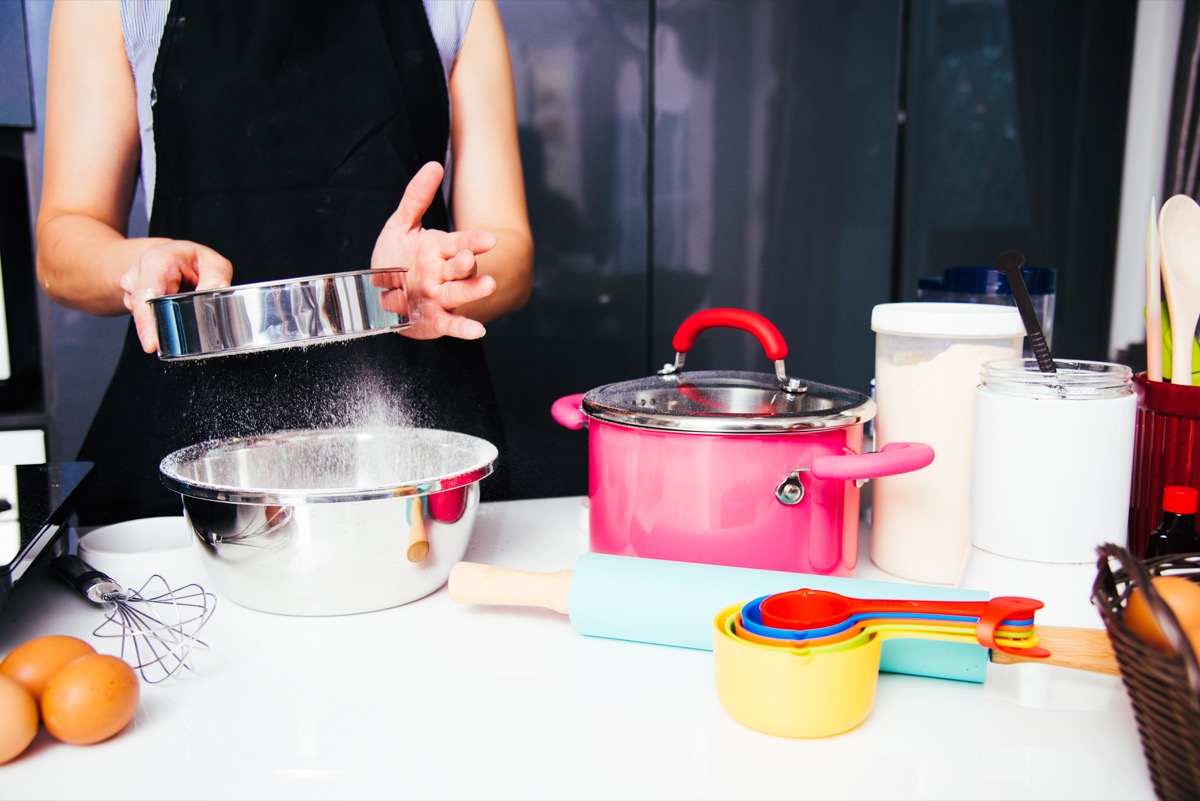 Woman Sifting Flour Cooking in the Kitchen Ways You Ruin Clothing
