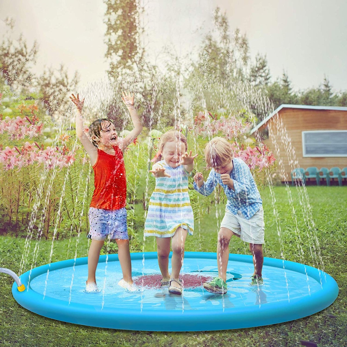 three children playing on sprinkler, best outdoor toys for toddlers