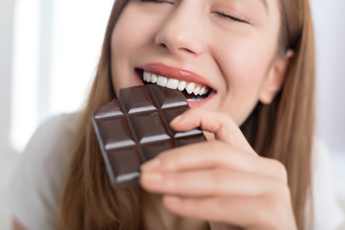 Woman enjoying a chocolate bar