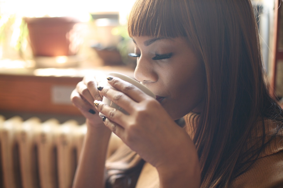 Black woman sipping on tea or coffee