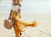 woman in yellow tote holding woven bag on the beach, luxury beach bags