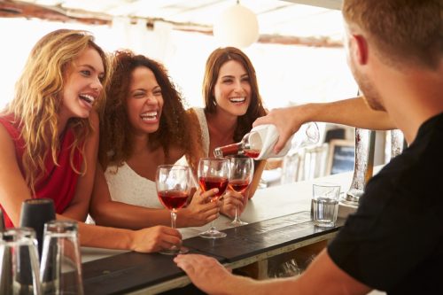 three women with glasses of wine laughing together, female friend, funny short jokes