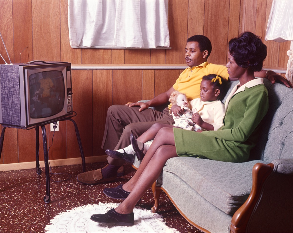 1970s Black Family, mom and dad and daughter, watches TV