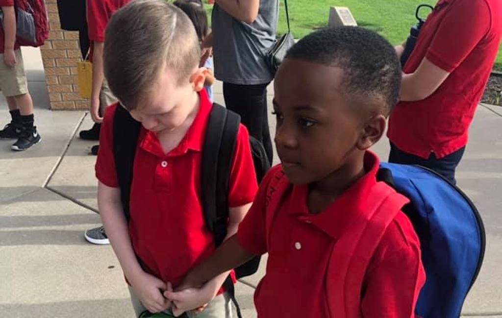 viral photo of boy comforting classmate with autism