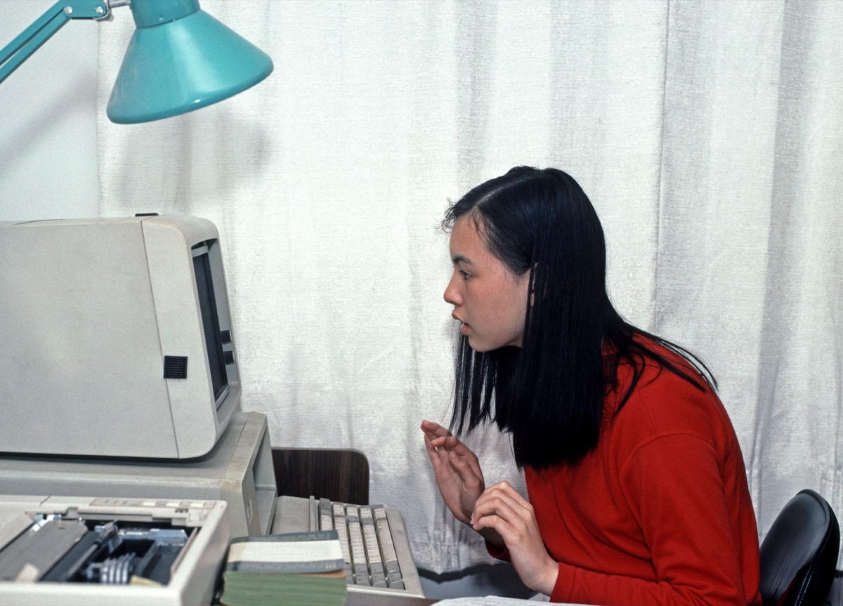 Asian girl using a PC home computer in 1990s