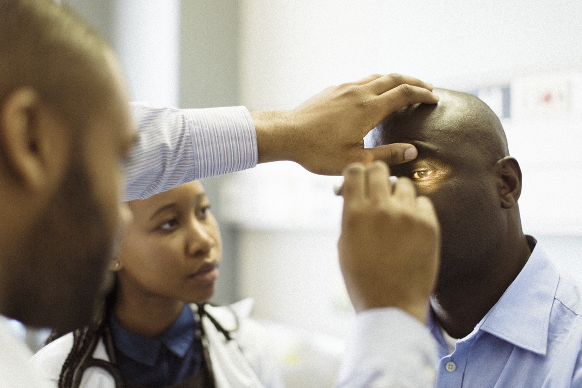 A doctor performing an eye examination in a hospital.