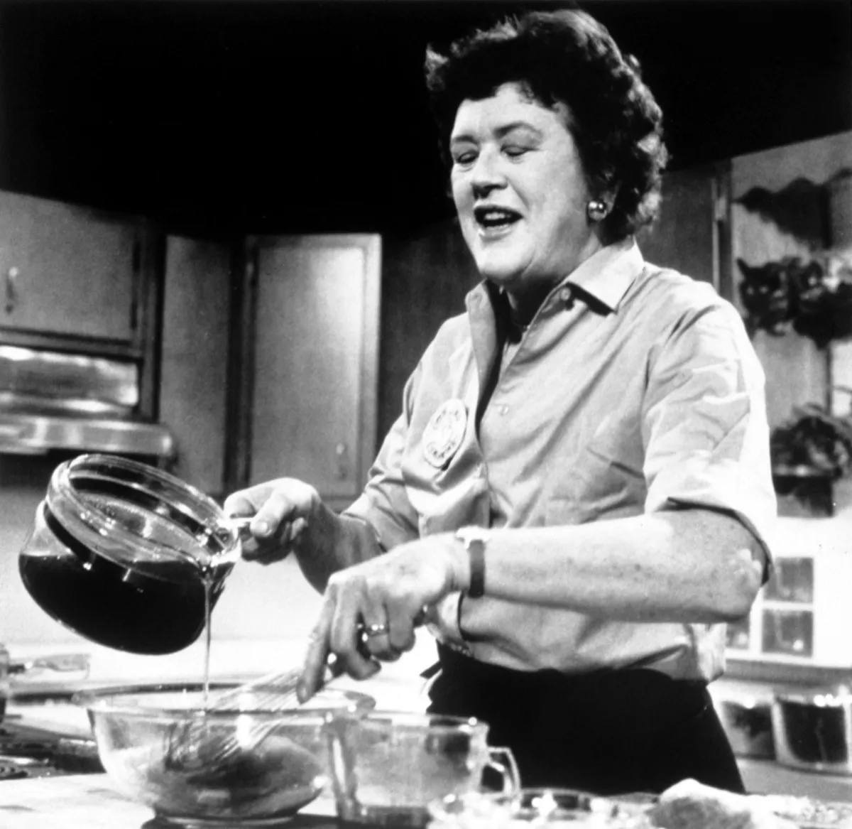 Julia Child cooking in a black and white photo