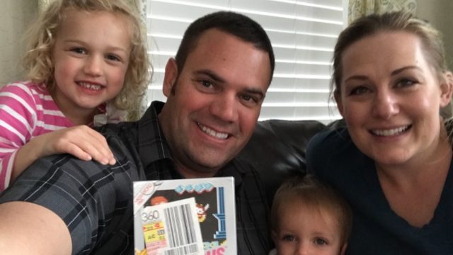 Scott Amos, who found 1980s video game Kid Icarus, with children and wife