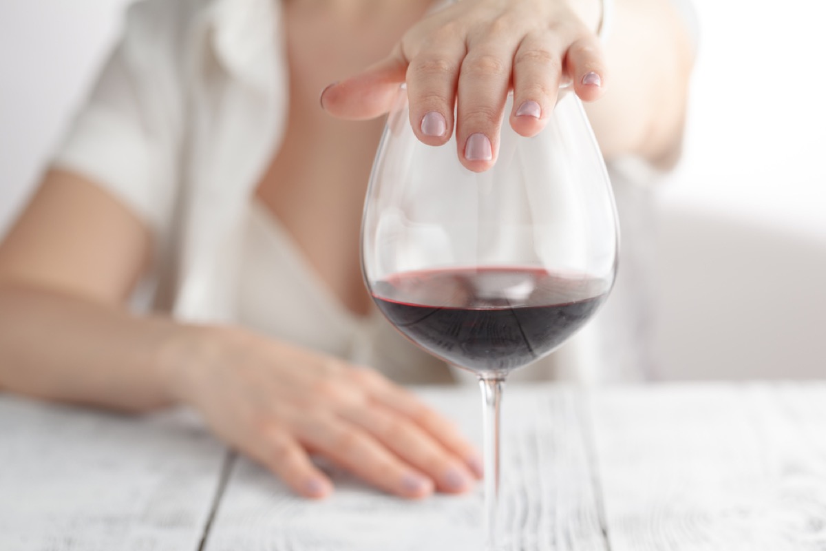 Woman's Hand on Glass of Wine