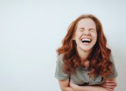 Young red-haired woman laughing