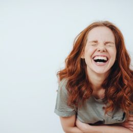 Young red-haired woman laughing