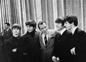 Photo of The Beatles with Ed Sullivan from their first appearance on Sullivan's US variety television program in February 1964. From left: Ringo Starr, George Harrison, Ed Sullivan, John Lennon, Paul McCartney.
