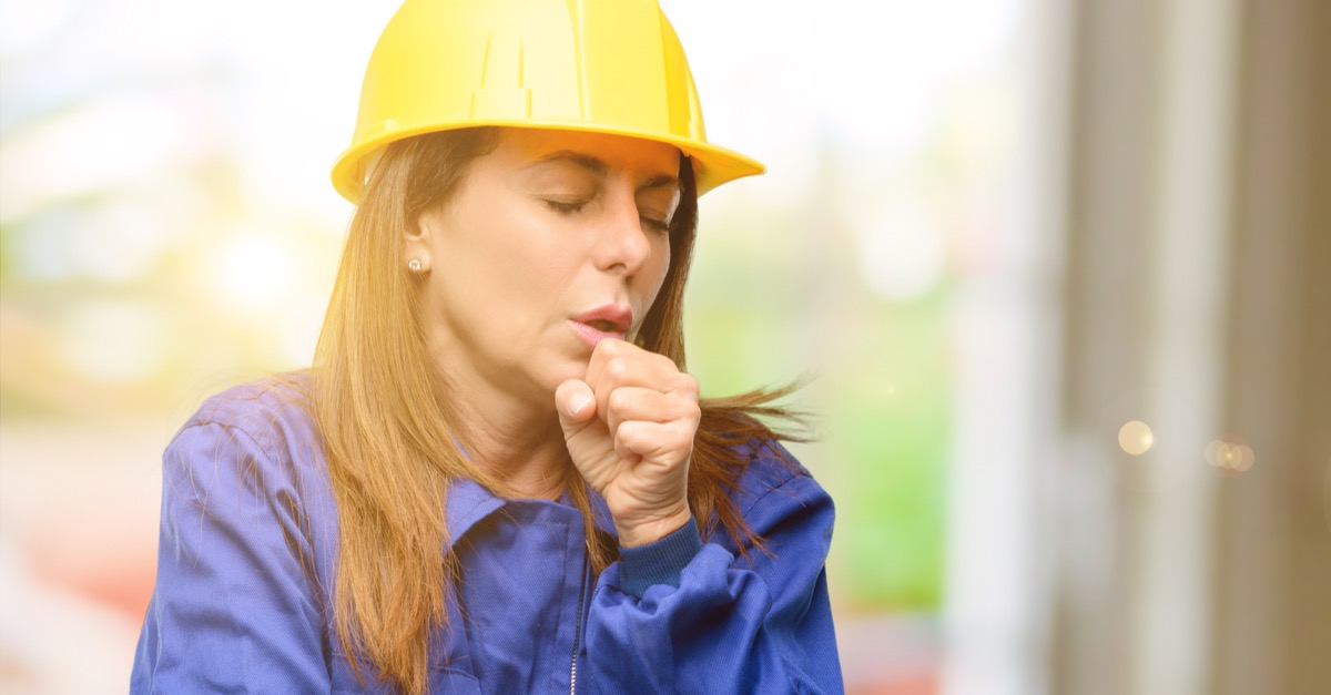 Construction worker coughing woman