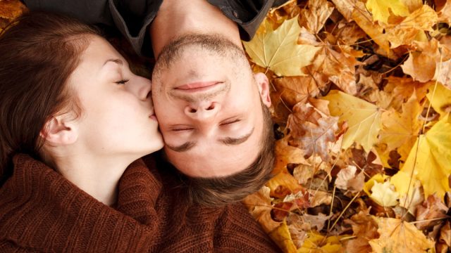 https://bestlifeonline.com/wp-content/uploads/sites/3/2019/08/couple-cheek-kiss-foliage.jpg?quality=82&strip=1&resize=640%2C360