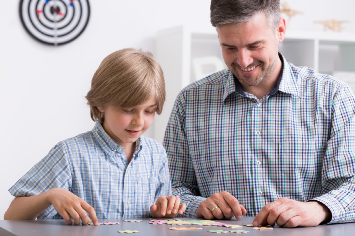 man and boy doing puzzle together, ways to feel amazing