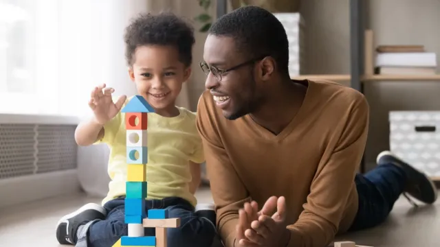 Dad playing with his toddler son things men won't admit