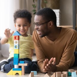 Dad playing with his toddler son things men won't admit