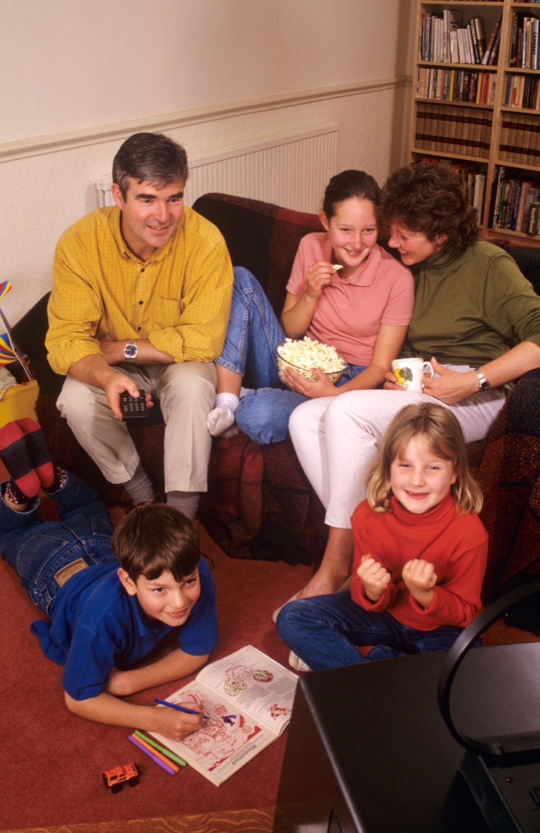 Family watching television together in the 1990s