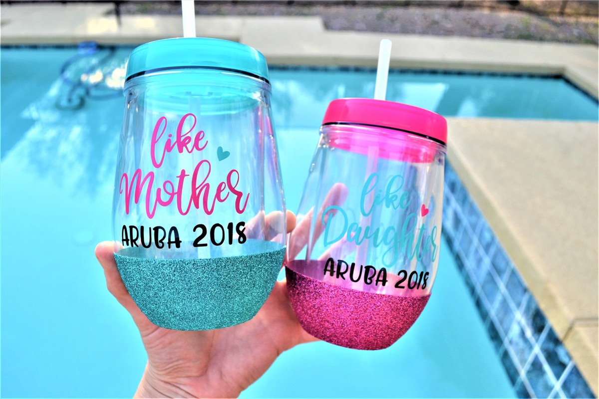 hand holding two goblets, one with green glitter, one with pink glitter, mother daughter gifts