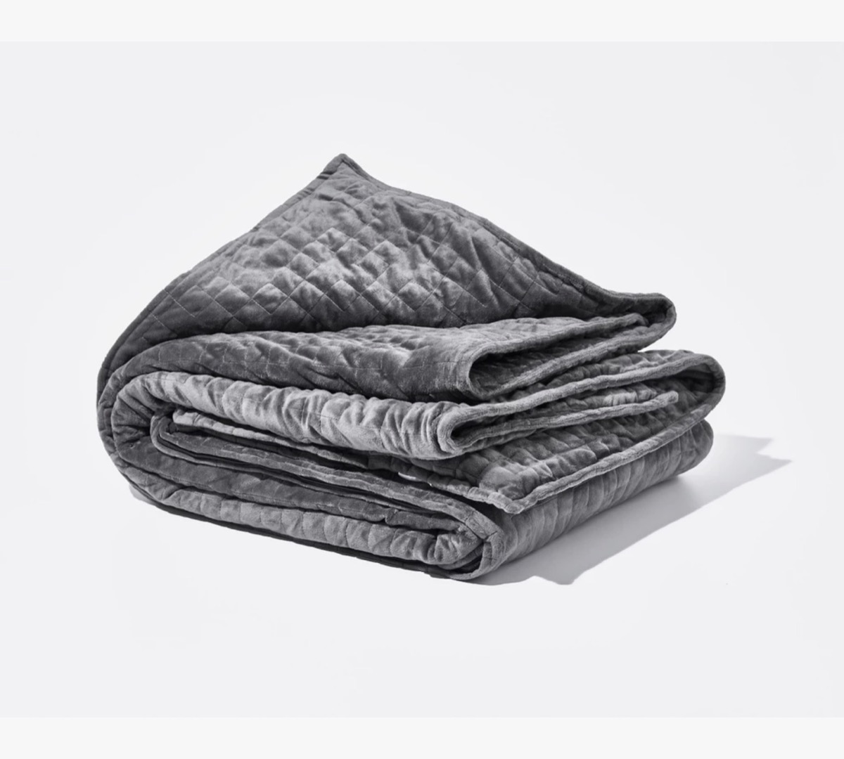 folded gray quilted blanket