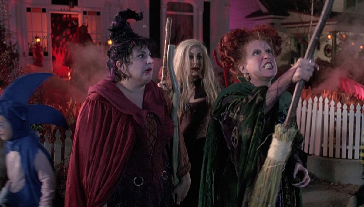 three actresses dressed as witches standing outdoors, hocus pocus movie still, best halloween movies for kids