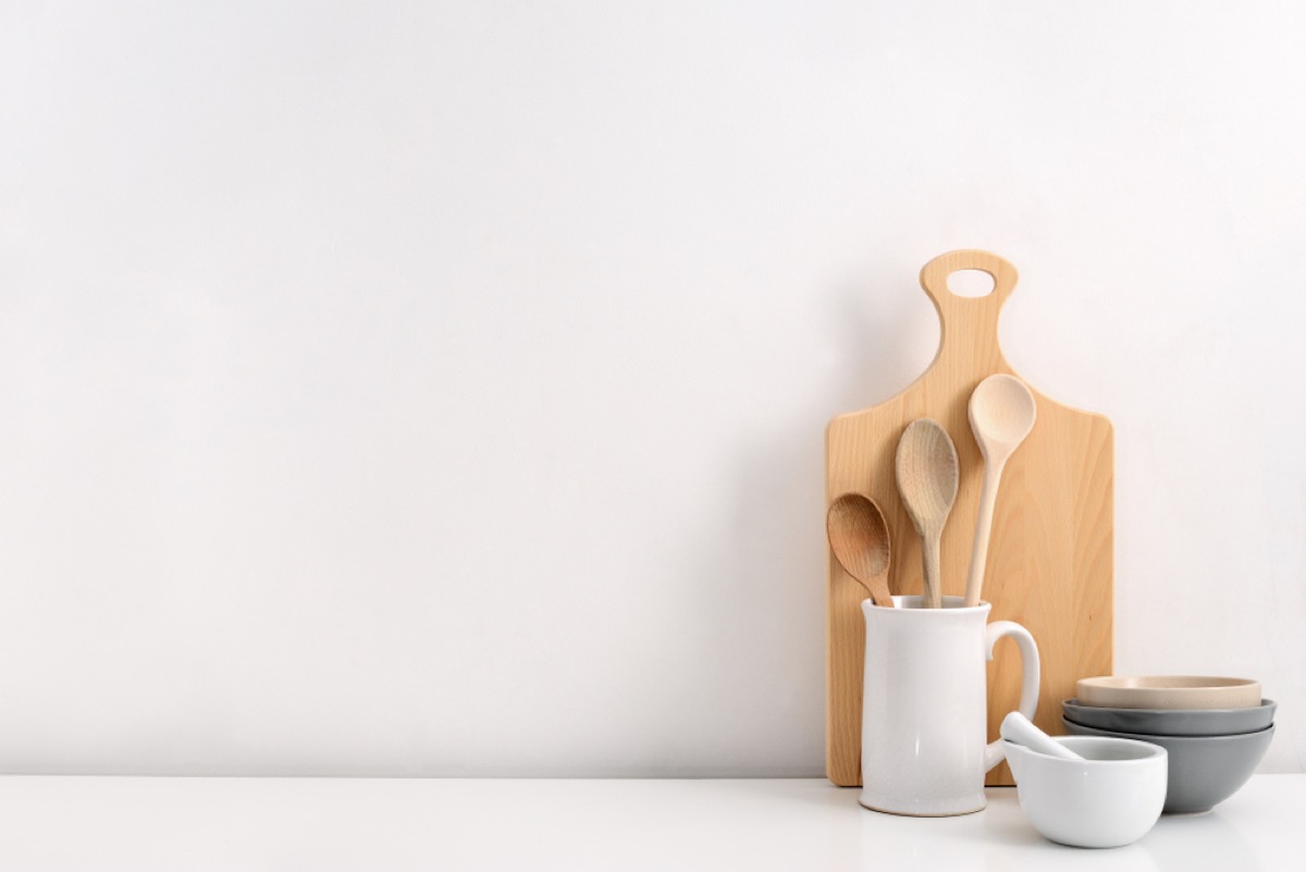 wooden spoons and cutting board against white wall, interior design mistakes