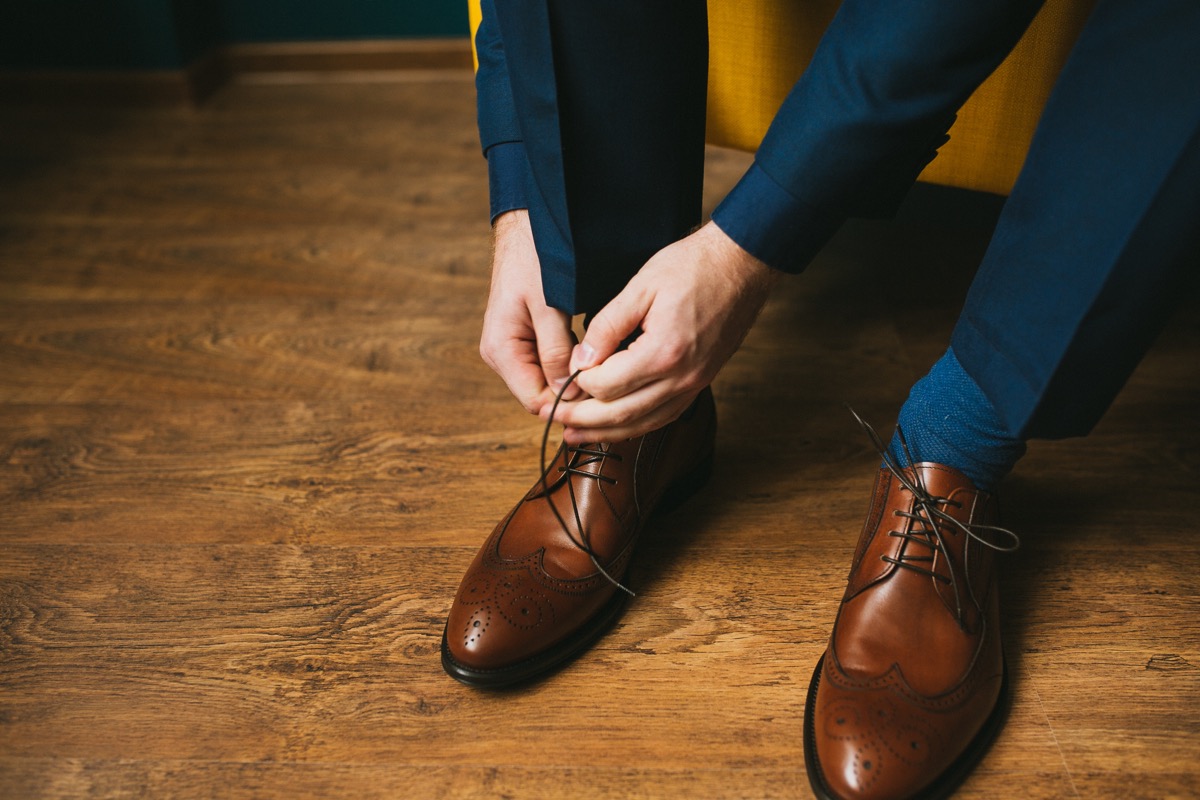man tying up his brogues coolest accessory every year