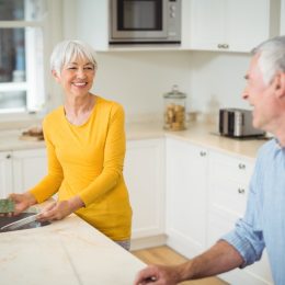 older white straight couple cleaning kitchen