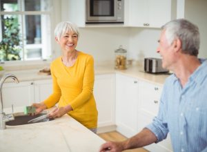 older white straight couple cleaning kitchen