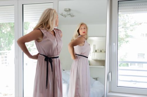 older woman looking in the mirror, things husband should notice