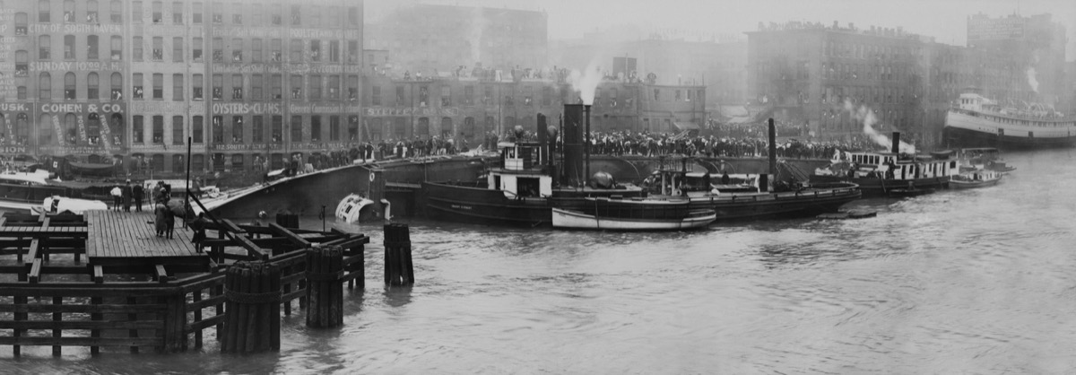 SS EASTLAND overturned in Chicago River, July 24, 1915. 844 passengers and crew were killed when the top-heavy ship, rolled completely onto its side when passengers crowded its port side. It was the largest loss of life from a single shipwreck on the Grea