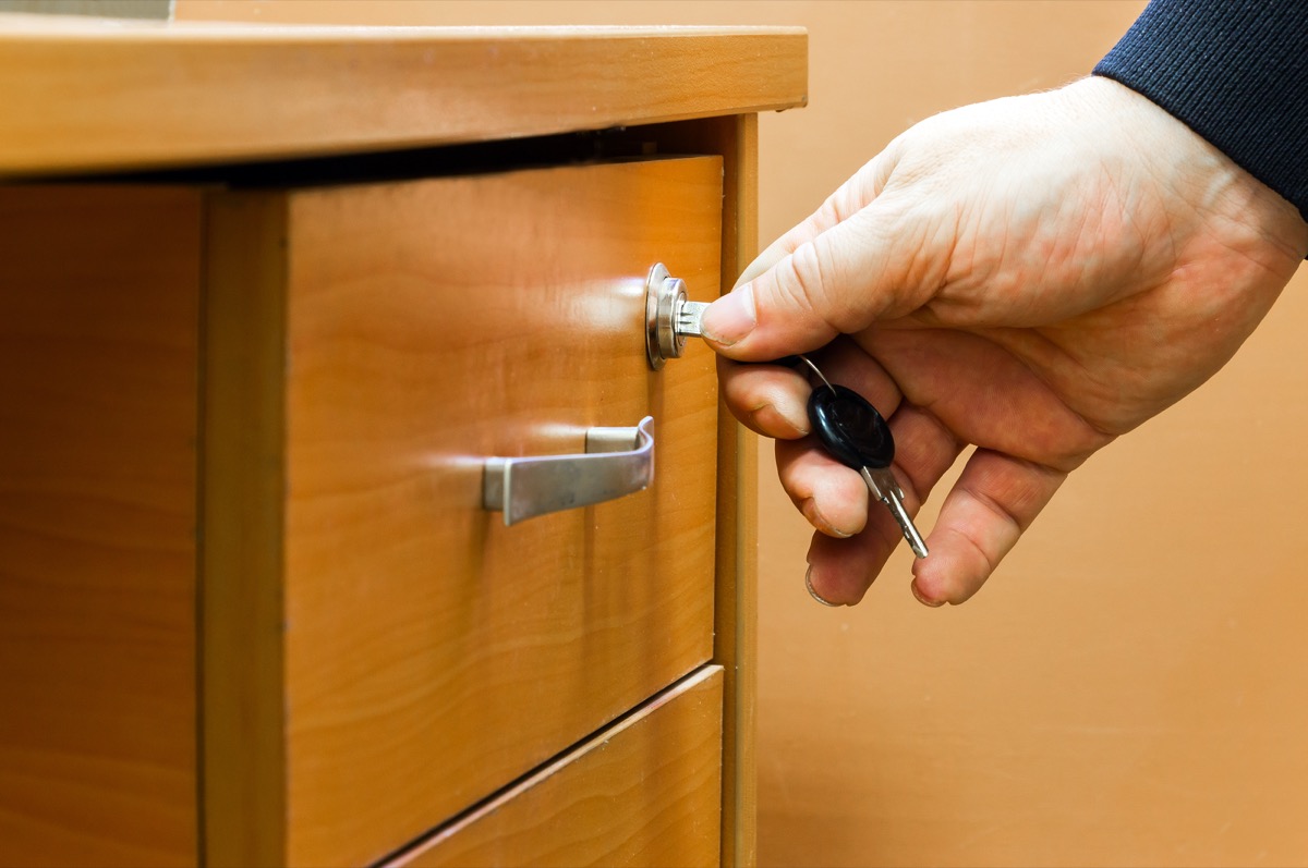man locking his desk drawer, your partner is hiding things