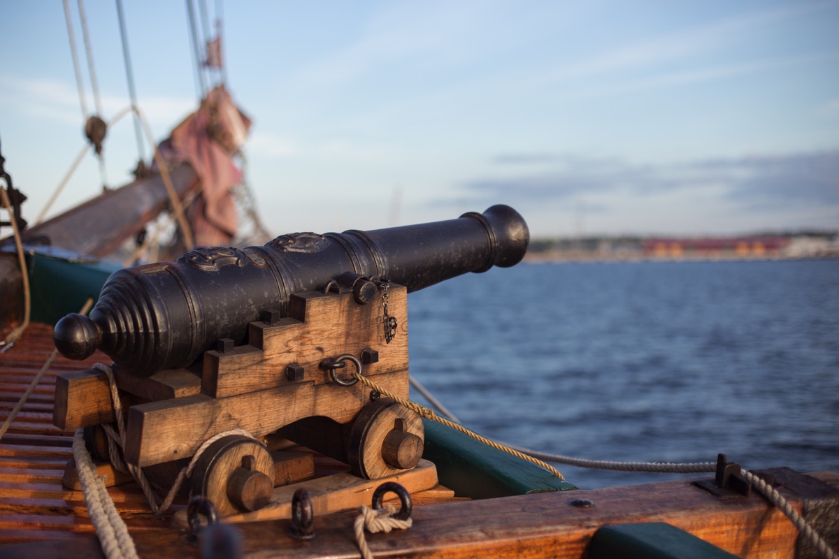old cannon on ship pointed at water