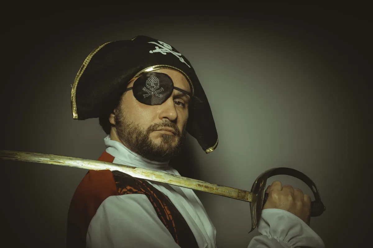 man dressed as pirate with eye patch and sword