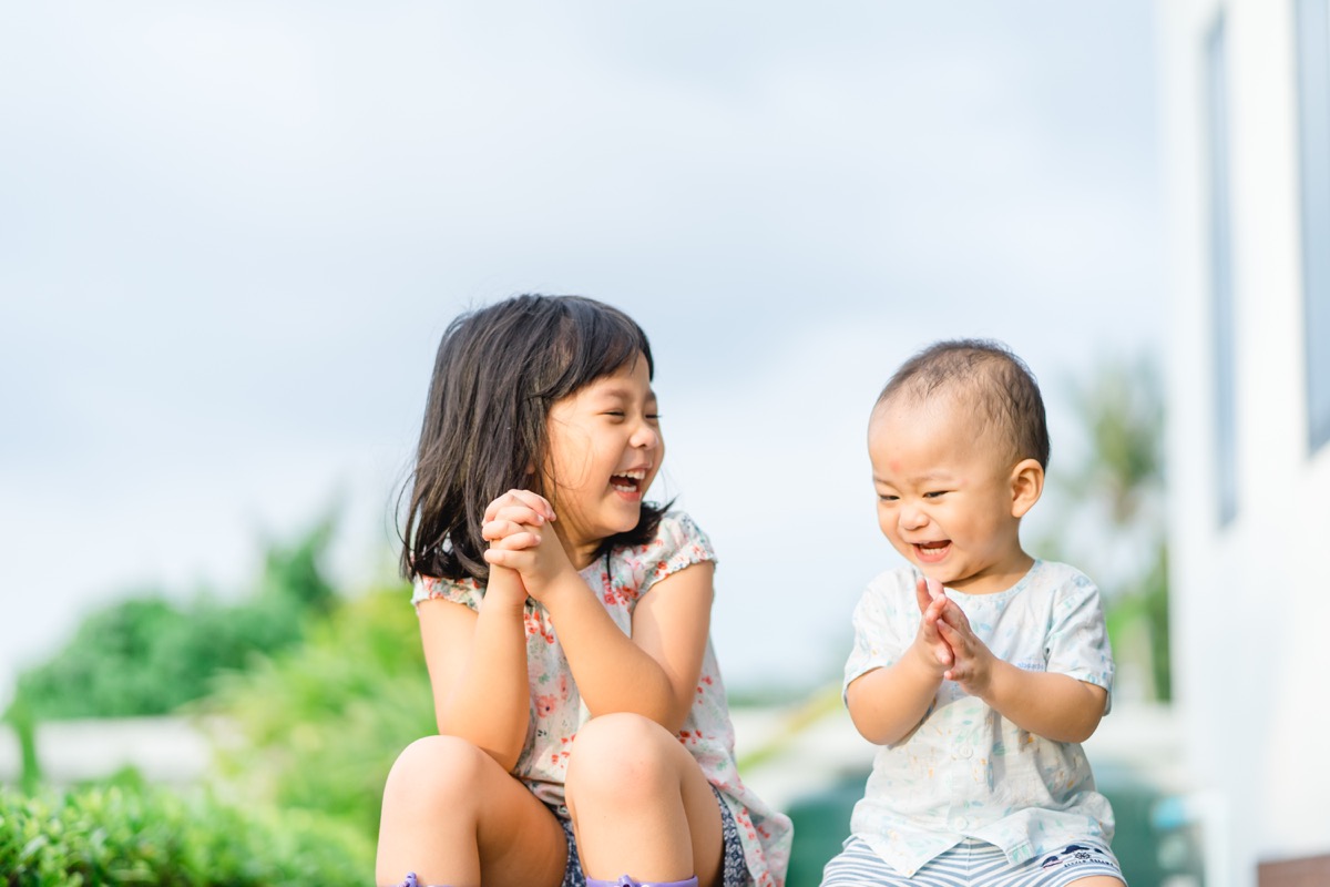 siblings laughing and playing together, middle child