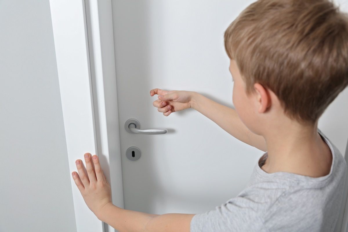 small boy knocks on door in home old-fashioned manners