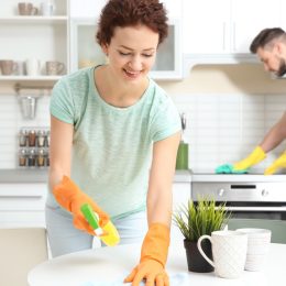 white couple cleaning kitchen in modern home