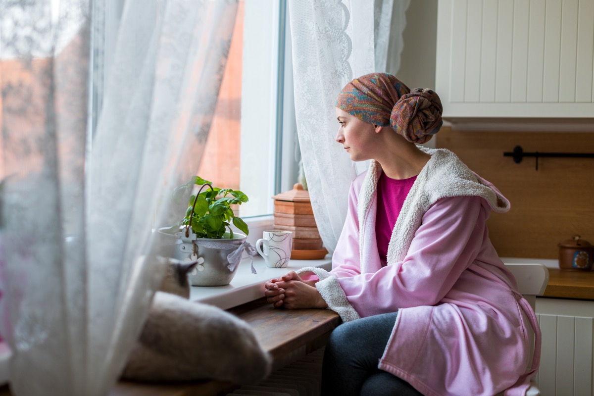 Woman with cancer looking out the window