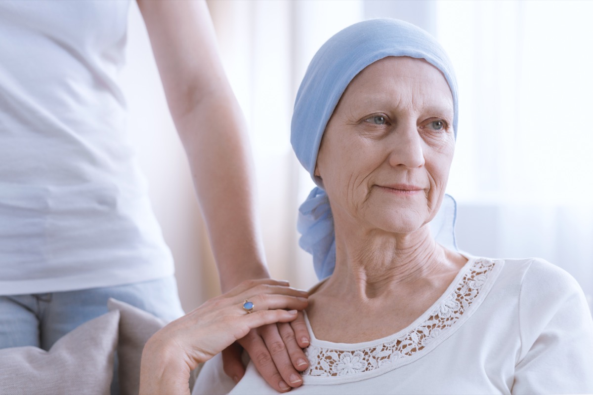 Woman with cancer holding hand