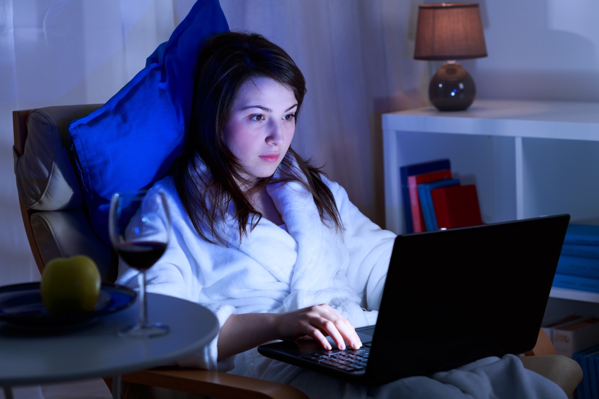Woman on her computer at night 