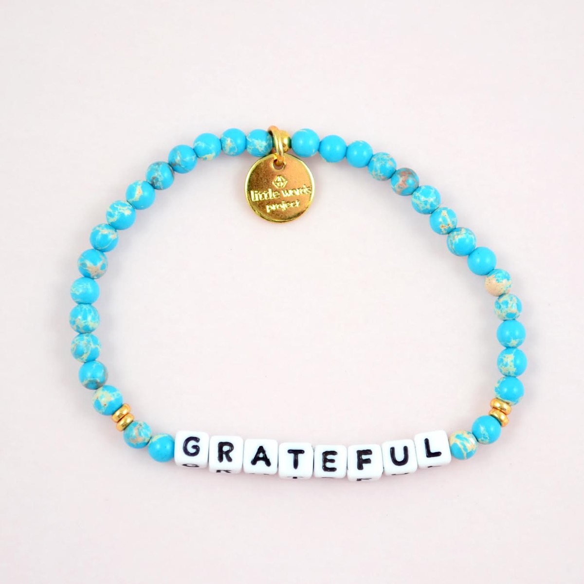 blue bracelet with grateful on it, little words project